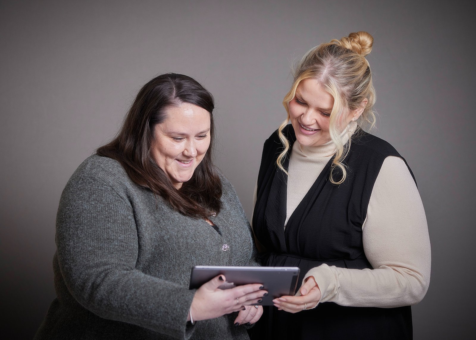 Dr. Charlotte Clark and Dr. Kirsty Gregory, looking at a tablet.