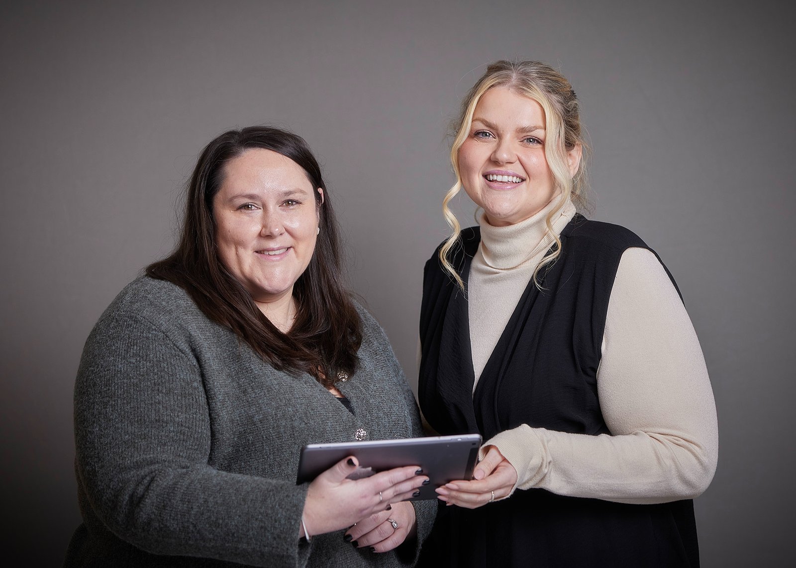 Dr. Charlotte Clark and Dr. Kirsty Gregory, looking at a tablet.